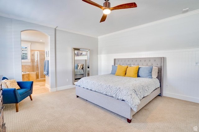 bedroom with light carpet, arched walkways, baseboards, and crown molding