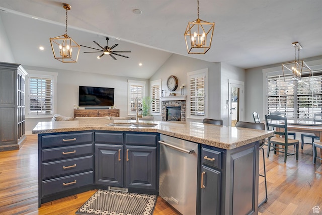kitchen with open floor plan, an inviting chandelier, a sink, and stainless steel dishwasher