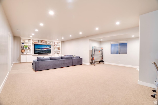 living room featuring baseboards, recessed lighting, light colored carpet, and built in shelves