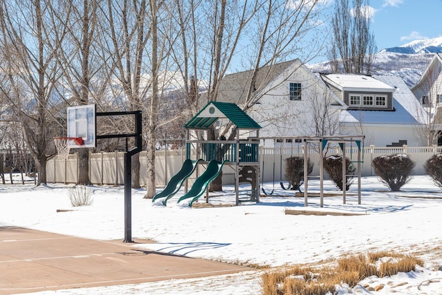 snow covered playground with fence and playground community
