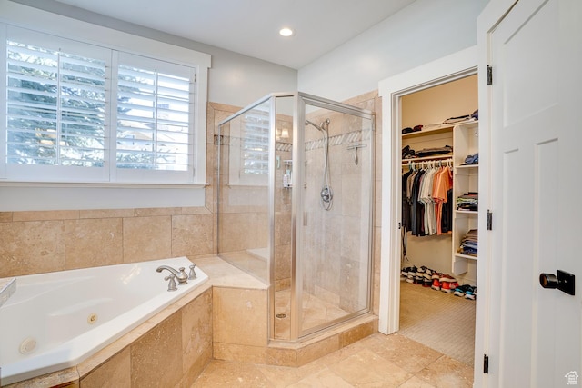 bathroom with a shower stall, tile patterned floors, a spacious closet, and a tub with jets