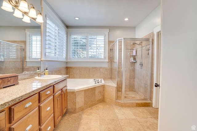 full bath with a stall shower, a garden tub, vanity, and recessed lighting