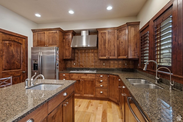 4048 W Ivy Ave, Mountain Green, UT 84050 - kitchen with stainless steel appliances, wall chimney range hood, a sink, light wood finished floors, and recessed lighting