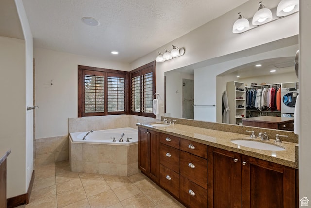 4048 W Ivy Ave, Mountain Green, UT 84050 - full bathroom featuring washer / dryer, a bath, tile patterned flooring, a walk in closet, and double vanity
