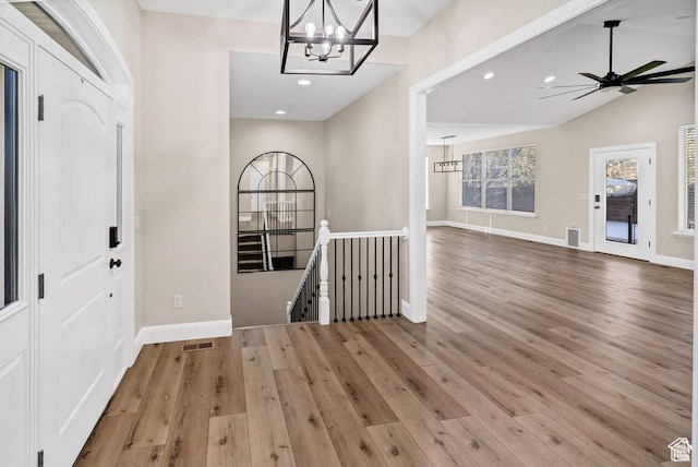 foyer entrance with a chandelier, wood finished floors, baseboards, recessed lighting, and ceiling fan