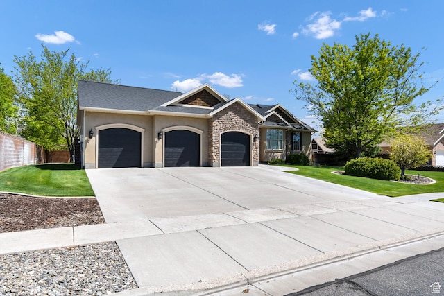 craftsman-style home with an attached garage, driveway, stucco siding, and stone siding