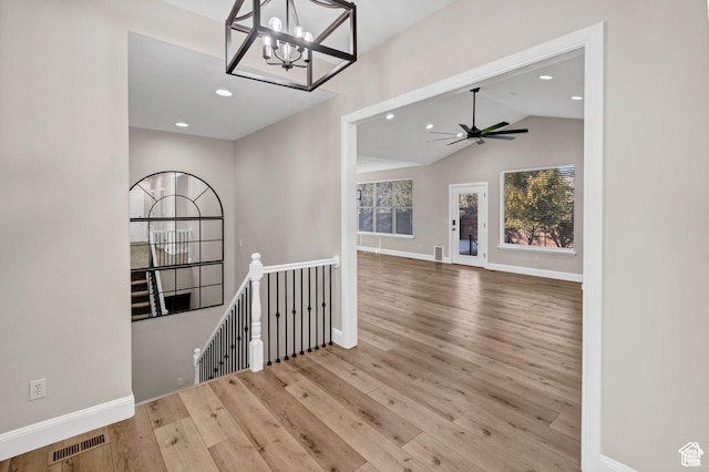 interior space featuring an upstairs landing, a chandelier, wood finished floors, recessed lighting, and baseboards