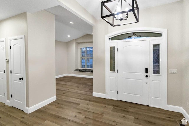 entrance foyer featuring a chandelier, wood finished floors, baseboards, and recessed lighting