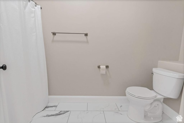 full bath featuring marble look tile flooring and baseboards