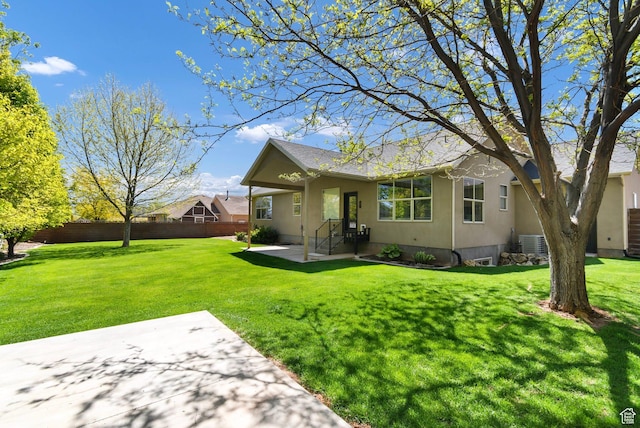 rear view of property with a patio, cooling unit, and roof with shingles
