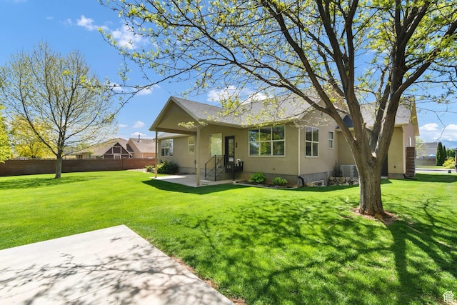 view of front of home with a patio area, stucco siding, and a shingled roof
