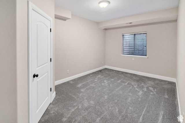 empty room with carpet floors and baseboards