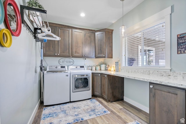 laundry room with separate washer and dryer, baseboards, recessed lighting, light wood-style floors, and cabinet space