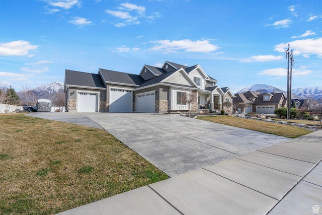 view of front of property featuring a garage, a front lawn, stone siding, and concrete driveway