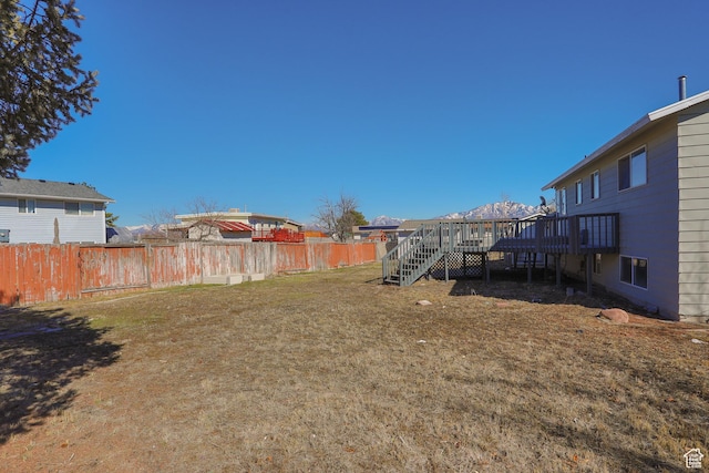 view of yard featuring a wooden deck and fence