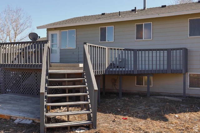 rear view of property with stairway and a wooden deck