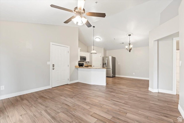 684 S 2150 W Unit 303, Pleasant Grove, UT 84062 - unfurnished living room featuring light wood-style flooring, ceiling fan with notable chandelier, baseboards, and vaulted ceiling
