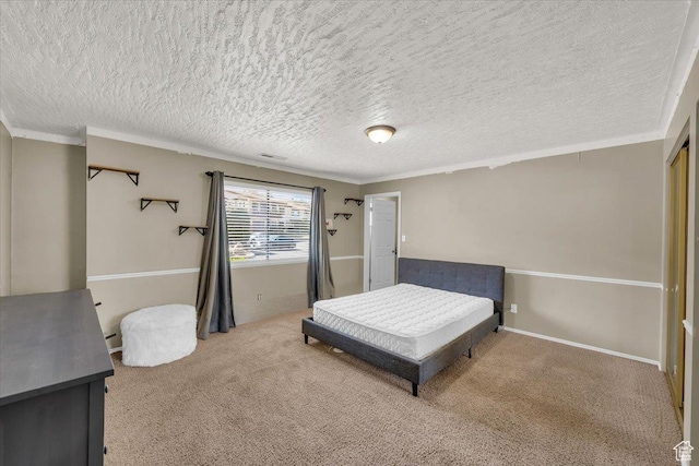 bedroom with a textured ceiling, visible vents, carpet floors, and ornamental molding