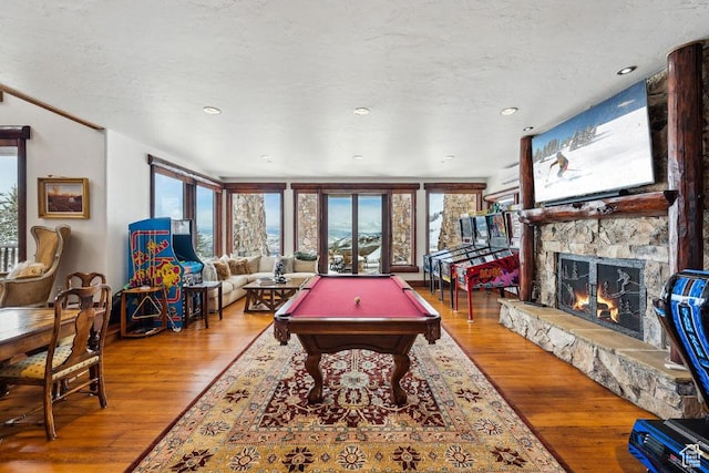 3438 Snow Top Ct, Park City, UT 84060 - recreation room with a wealth of natural light, wood-type flooring, a textured ceiling, and a fireplace