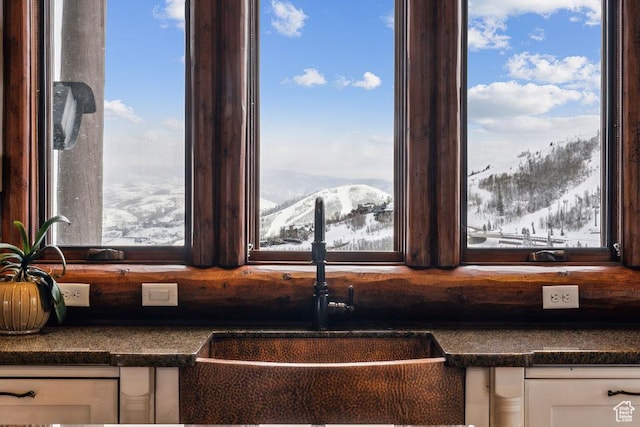 3438 Snow Top Ct, Park City, UT 84060 - details with dark countertops, white cabinets, a mountain view, and a sink
