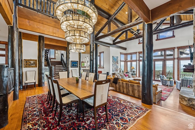 3438 Snow Top Ct, Park City, UT 84060 - dining room featuring a chandelier, stairs, a towering ceiling, hardwood / wood-style flooring, and a wooden ceiling with exposed beams