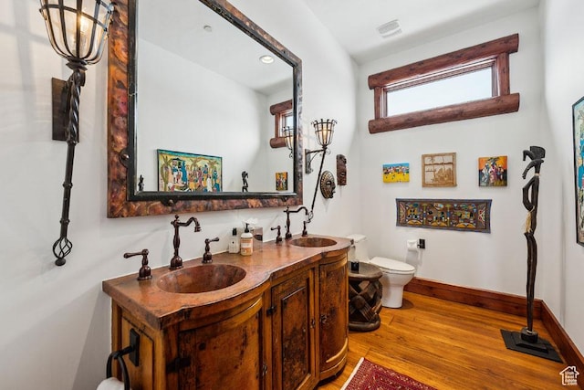 3438 Snow Top Ct, Park City, UT 84060 - bathroom with wood finished floors, visible vents, double vanity, a sink, and toilet