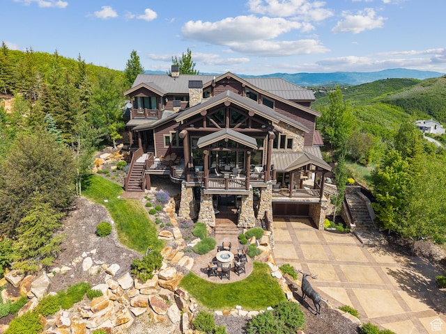 3438 Snow Top Ct, Park City, UT 84060 - view of front of home featuring a metal roof, stairway, driveway, stone siding, and a garage