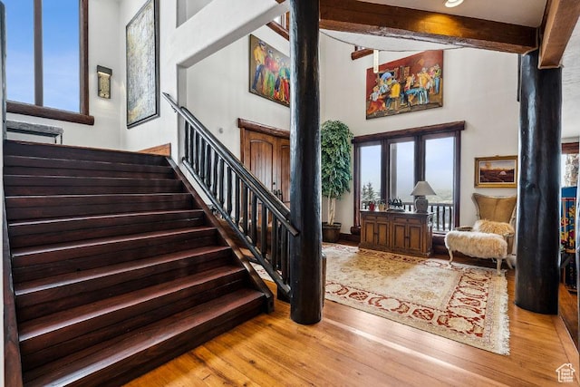 3438 Snow Top Ct, Park City, UT 84060 - foyer entrance featuring beam ceiling, stairs, a high ceiling, and wood finished floors