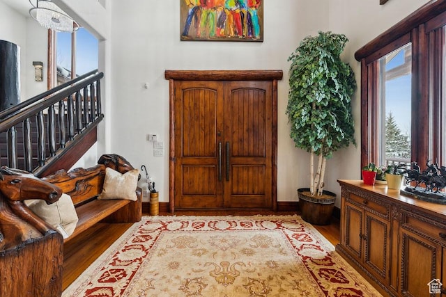 3438 Snow Top Ct, Park City, UT 84060 - entrance foyer with a notable chandelier, stairs, baseboards, and wood finished floors