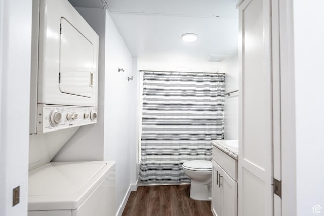 443 Kane Creek Blvd Unit 111, Moab, UT 84532 - full bathroom with baseboards, toilet, stacked washing maching and dryer, wood finished floors, and vanity