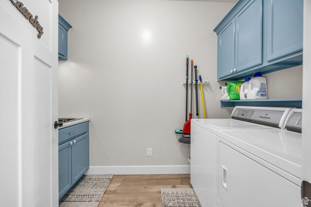 203 E Deer Run Loop Unit 40, Elk Ridge, UT 84651 - washroom featuring washing machine and clothes dryer, cabinet space, light wood finished floors, and baseboards