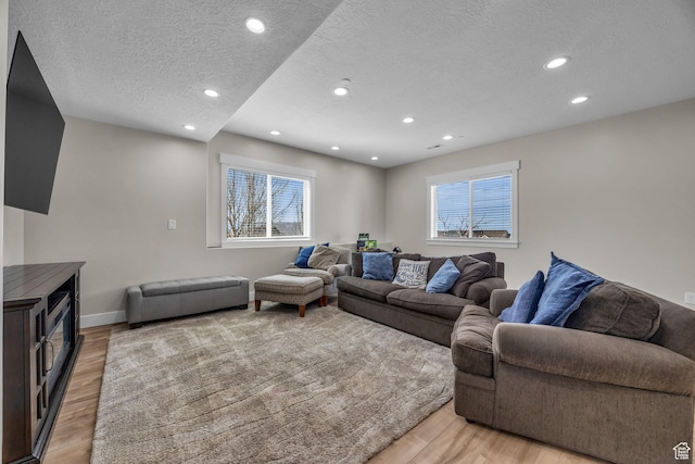 203 E Deer Run Loop Unit 40, Elk Ridge, UT 84651 - living area featuring a textured ceiling, light wood-style flooring, recessed lighting, and baseboards