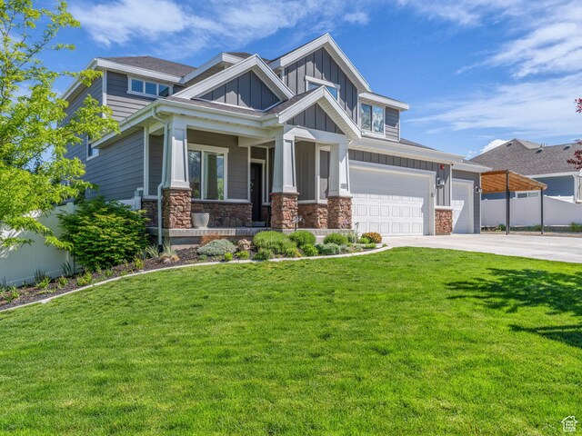 203 E Deer Run Loop Unit 40, Elk Ridge, UT 84651 - craftsman inspired home featuring board and batten siding, concrete driveway, stone siding, and covered porch