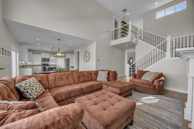 203 E Deer Run Loop Unit 40, Elk Ridge, UT 84651 - living room featuring stairway, a high ceiling, recessed lighting, and wood finished floors