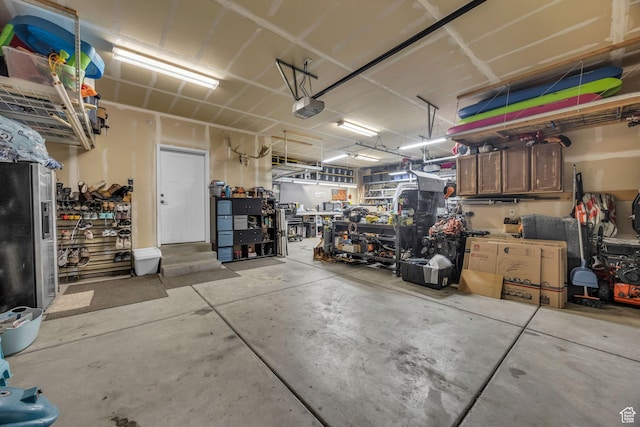 203 E Deer Run Loop Unit 40, Elk Ridge, UT 84651 - garage featuring a garage door opener and a workshop area