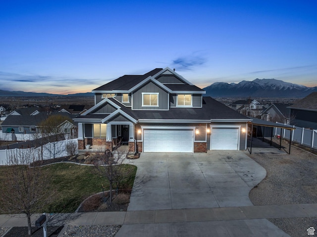 203 E Deer Run Loop Unit 40, Elk Ridge, UT 84651 - view of front of house featuring an attached garage, concrete driveway, a mountain view, and a porch