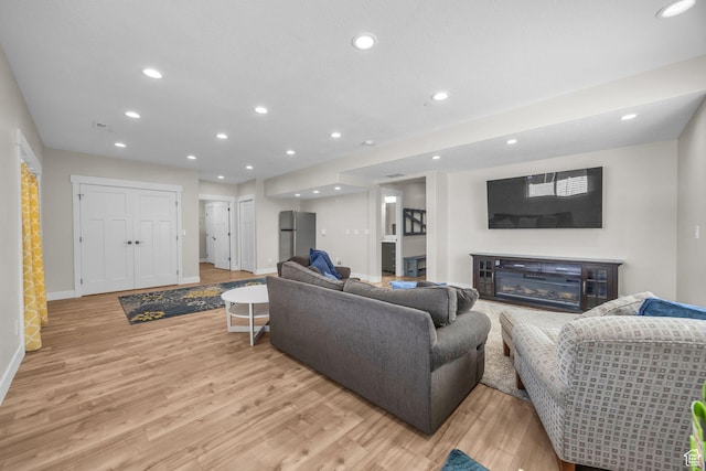 203 E Deer Run Loop Unit 40, Elk Ridge, UT 84651 - living room with light wood-style floors, baseboards, recessed lighting, and a glass covered fireplace