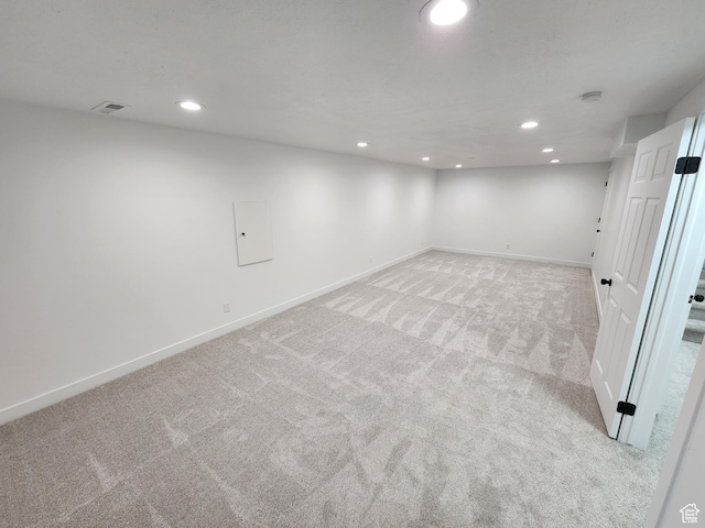 finished below grade area with recessed lighting, baseboards, and light carpet