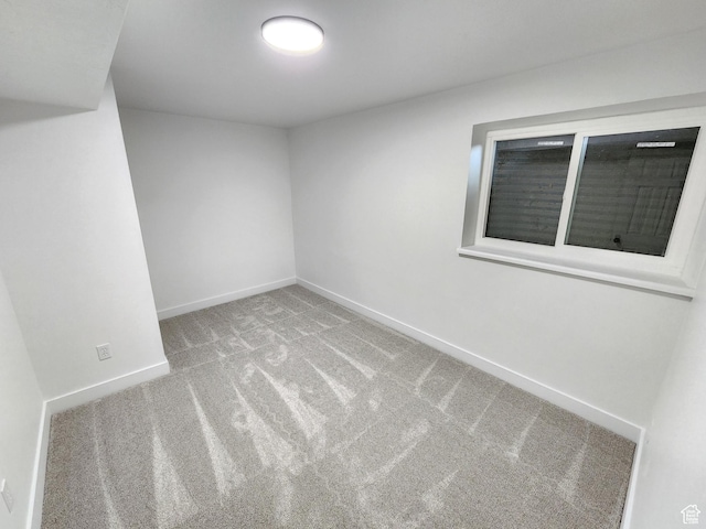 unfurnished room featuring baseboards and carpet floors