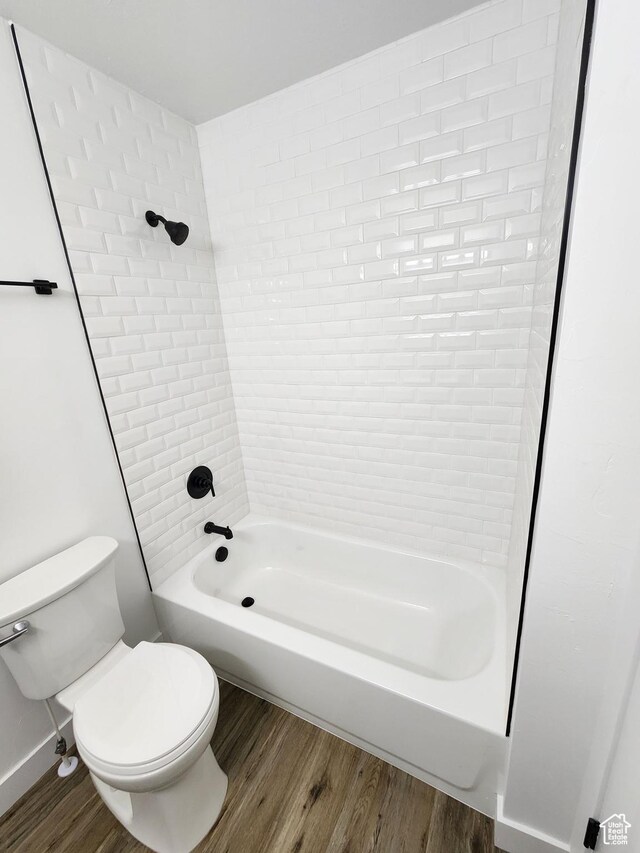 full bathroom featuring toilet,  shower combination, and wood finished floors