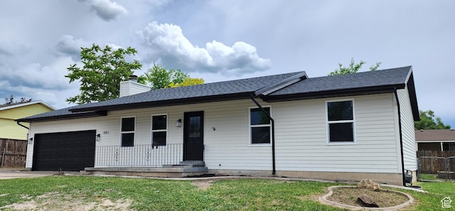 ranch-style house featuring a porch, fence, a front yard, a garage, and a chimney
