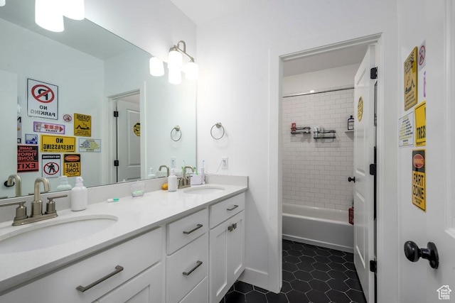 bathroom with a sink, double vanity, and tile patterned flooring