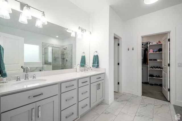 bathroom with a sink, marble finish floor, a stall shower, and a spacious closet