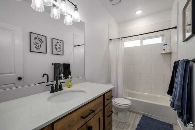 bathroom with vanity, shower / tub combo, toilet, and wood finished floors