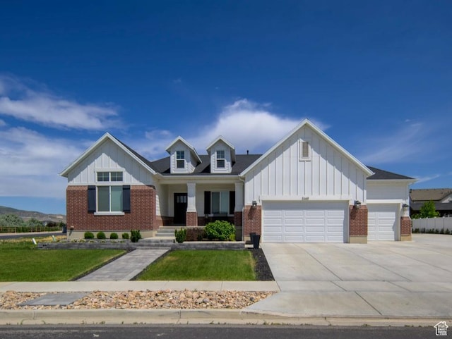 2660 W 1080 N, Lehi, UT 84043 - view of front of house with board and batten siding, brick siding, a garage, and concrete driveway