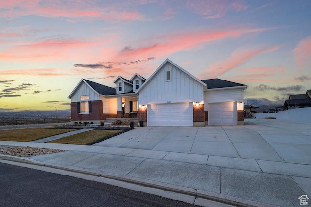view of front of home with concrete driveway, an attached garage, and board and batten siding