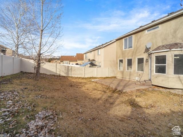 7009 W 7895 S, West Jordan, UT 84081 - view of yard featuring a patio area and a fenced backyard