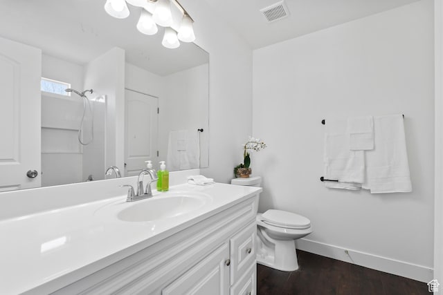 7009 W 7895 S, West Jordan, UT 84081 - bathroom with vanity, wood finished floors, baseboards, visible vents, and toilet