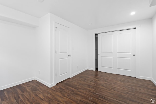 7009 W 7895 S, West Jordan, UT 84081 - unfurnished bedroom featuring dark wood finished floors, recessed lighting, a closet, and baseboards