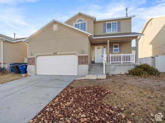 7009 W 7895 S, West Jordan, UT 84081 - traditional-style house featuring fence, a porch, concrete driveway, stucco siding, and an attached garage
